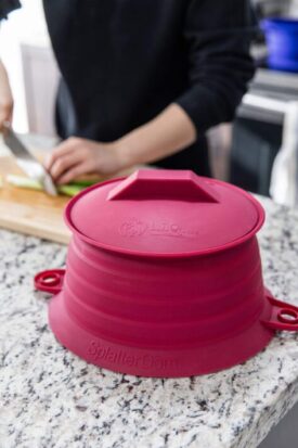 LīQ Home Bordeaux SplatterDōm splatter guard microwave ready on kitchen counter beside food preparation area