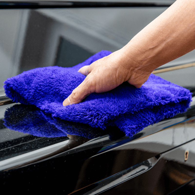 LīQ Home heavy pile purple microfiber cloth dusting a piano surface