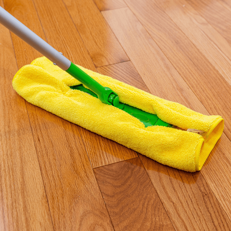 long pile yellow microfibre cloth mopping hard wood floors.